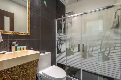 a bathroom with a shower and a toilet and a sink at GuestReady - Palms at heaven's door in Dubai