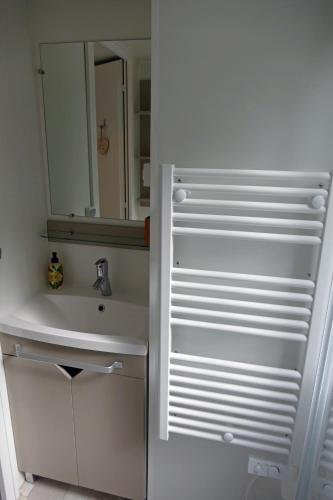 a white bathroom with a sink and a mirror at VerandaChalet 6p centrally located in National Park, Swimming pool 164 in Wateren