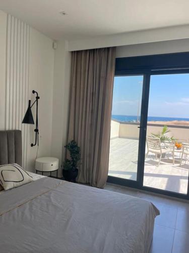 a bedroom with a bed and a view of the ocean at Luxury Villa with pool 1st line the sea in Torrevieja