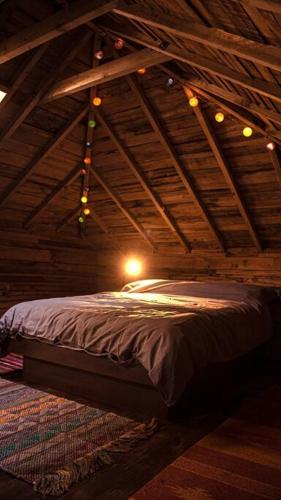 a bedroom with a bed in a wooden ceiling at The Bristol Coach House in the heart of Bishopston in Bristol