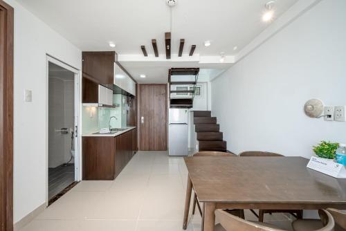 a kitchen and dining room with a table and chairs at Cozrum Homes - Sonata Residence in Ho Chi Minh City