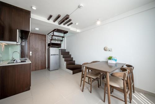 a kitchen and dining room with a table and chairs at Cozrum Homes - Sonata Residence in Ho Chi Minh City