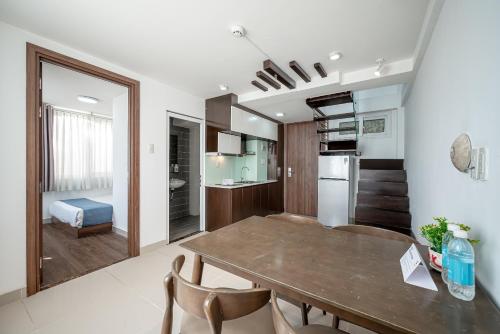 a kitchen and dining room with a table and chairs at Cozrum Homes - Sonata Residence in Ho Chi Minh City