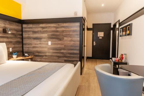 a bedroom with a bed and a tub in a room at Catalina Hotel & Beach Club in Miami Beach