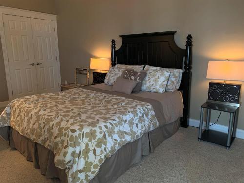 a bedroom with a large bed with two lamps at Pier Harbor #2 in Saint Ignace