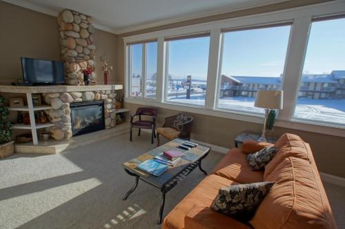 a living room with a couch and a fireplace at Pier Harbor #1 & #2 in Saint Ignace