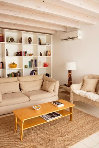 a living room with two couches and a coffee table at Casa do Almirante in Tavira