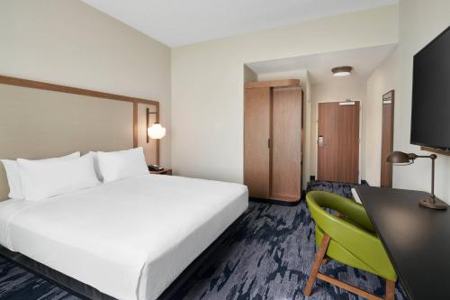 a hotel room with a bed and a desk at Fairfield Inn & Suites Tampa Riverview in Riverview