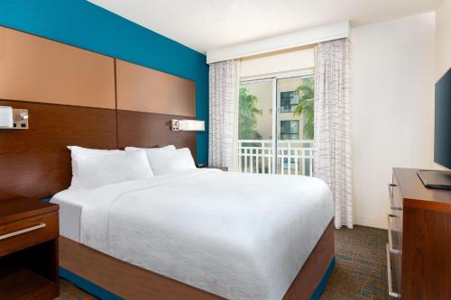 a bedroom with a large bed and a window at Residence Inn Tampa Downtown in Tampa