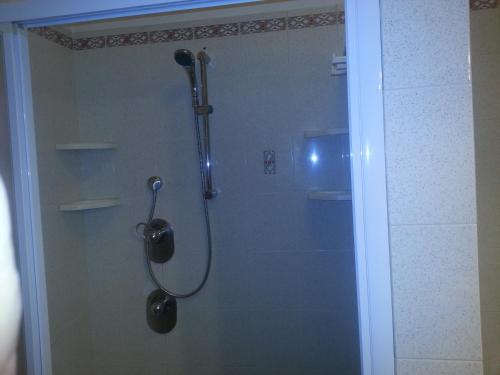 a shower in a bathroom with a glass door at Al Villino del Sole in Fano