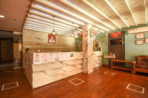 a restaurant with a counter in a room at Super OYO Ssj Residency in Khandagiri