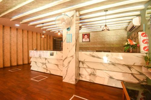 a lobby with a marble wall in a building at OYO Ssj Residency in Khandagiri