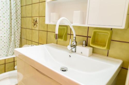 a bathroom with a white sink and a mirror at My Aegean Sea Apartment in Kos