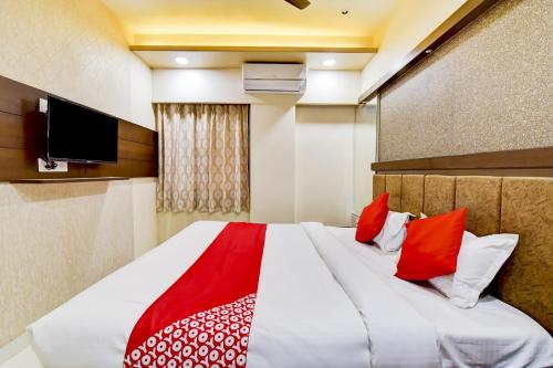 una camera da letto con un grande letto con cuscini rossi di Suman Palace a Ajmer