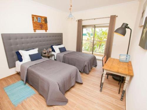 Postel nebo postele na pokoji v ubytování Jardins da Marina Albufeira