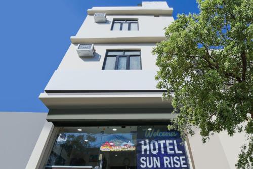a hotel sun rise sign in front of a building at Hotel Sunrise in Ludhiana