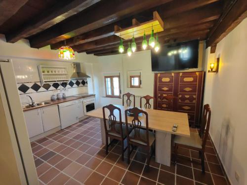 cocina y comedor con mesa y sillas en La canongia, en Segovia