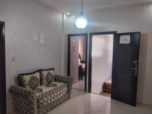 a living room with a couch and a door at Mohamed V Airport Home in Deroua