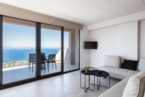 a living room with a couch and a table at Saronida Hills in Saronida