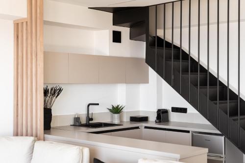 a kitchen with a sink and a staircase at Saronida Hills in Saronida