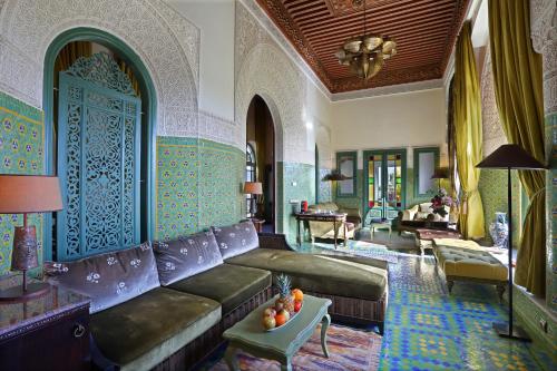 a living room with a couch and a table at Palais Faraj Suites & Spa in Fès