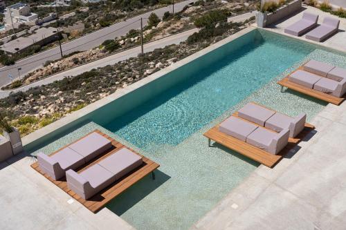 an overhead view of a swimming pool with two lounge chairs at Saronida Hills in Saronida