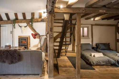 a living room with a loft bed and a ladder at West Street Loft in Midhurst