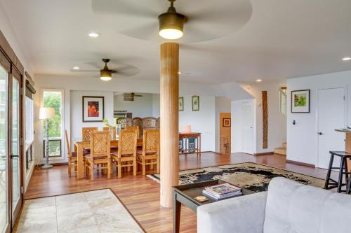 a dining room and living room with a table and chairs at Hilo Home with Private Deck and Stunning Ocean Views! in Hilo