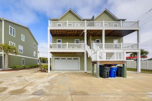 a house with a balcony and a garage at Emerald Isle Getaway with Decks and Beach Views! in Emerald Isle