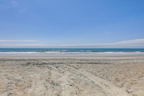 an empty beach with the ocean in the background at Emerald Isle Getaway with Decks and Beach Views! in Emerald Isle
