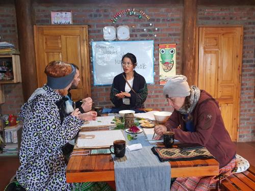 a group of people sitting around a table at La Beauté Sa Pa in Sa Pa