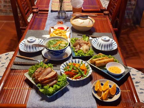 a table topped with plates of food and bowls of food at La Beauté Sa Pa in Sa Pa