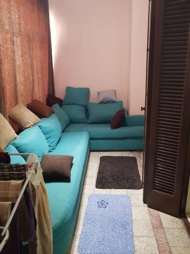 un soggiorno con divano blu in una camera di شقة مفروشة للايجار فى مصر الجديده مدة قصيرة باليوم a Il Cairo