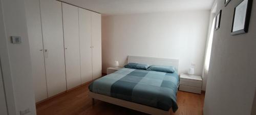 a small bedroom with a bed and white cabinets at Sa Domo de Paolo in Alghero