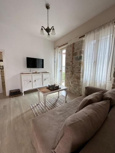 a living room with a couch and a table at Stone Villa in Pythagoreio