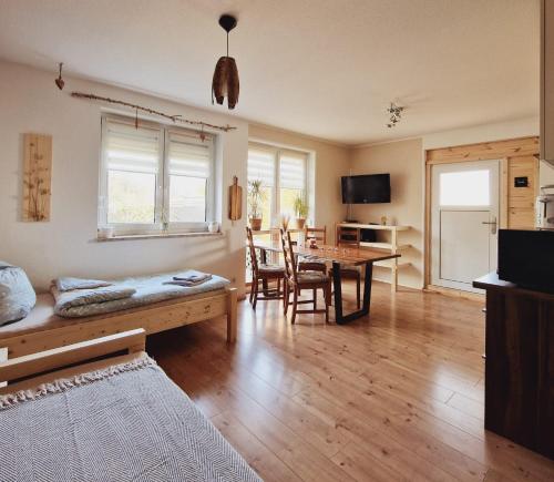 a living room with a table and a dining room at Ferienwohnung Sunny in Mittenwalde