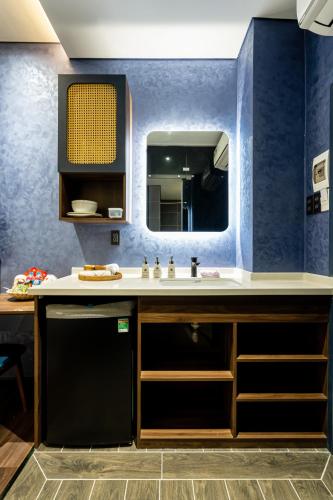 a bathroom with a sink and a mirror at KunKin Garden Aparthotel in Ho Chi Minh City