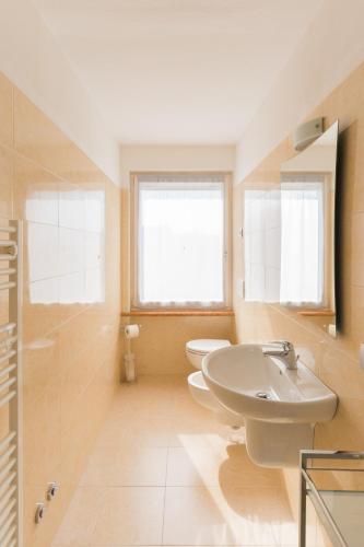 a bathroom with two toilets and a sink at Appartamenti Ceccherini in Malcesine