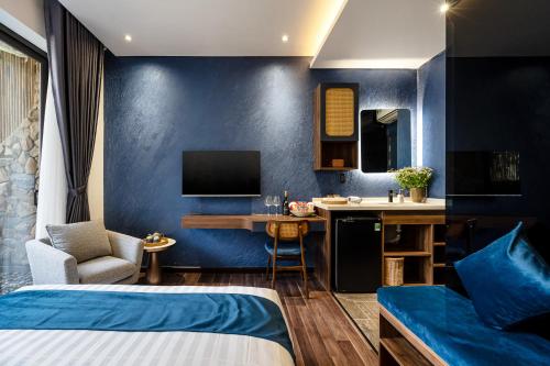 a hotel room with two beds and a kitchen with a desk at KunKin Garden Aparthotel in Ho Chi Minh City