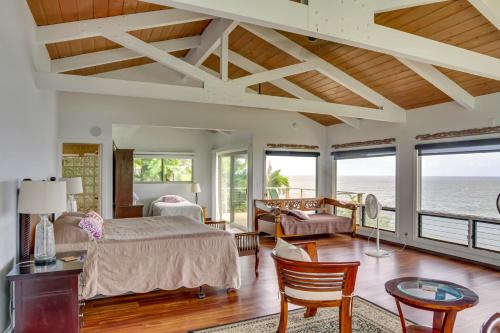 a bedroom with a bed and a table and chairs at Hilo Home with Private Deck and Stunning Ocean Views! in Hilo