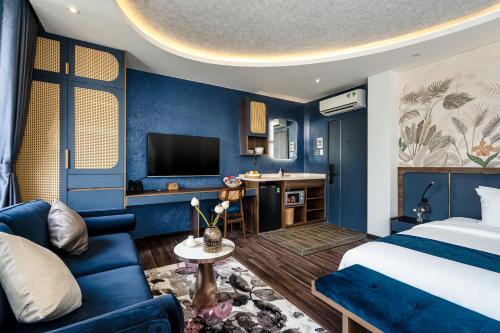 a hotel room with a bed and a tv at KunKin Garden Aparthotel in Ho Chi Minh City