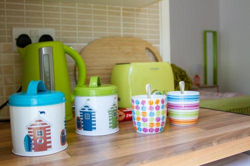 a group of cups sitting on top of a table at Krissie's in Marazion