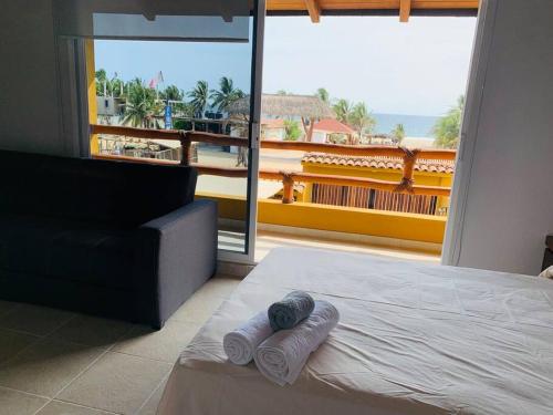 a bedroom with a bed and a view of the ocean at Casa Hipocampo in El Coacoyul