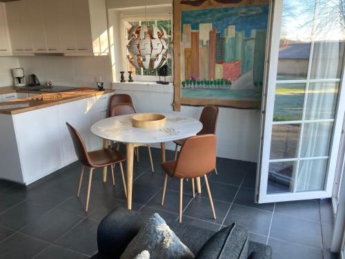 a kitchen with a table and chairs in a kitchen at Hegedal Apartment in Hobro