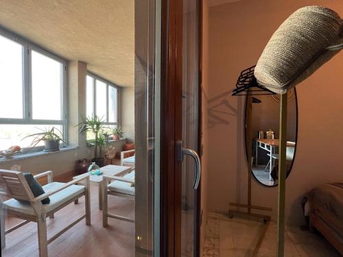 a living room with a mirror and a lamp in a room at ORODIMORA Milano in Milan