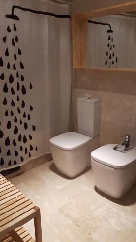 a bathroom with a toilet and a shower curtain at APARTAMENTO TURÍSTICO CARBONERAS in Carboneras