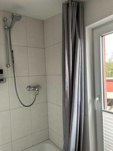 a bathroom with a shower with a shower curtain at House Susanne in Cologne