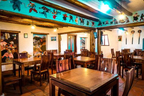 a dining room with wooden tables and chairs at Comunidad La Moya, Calpi in Riobamba