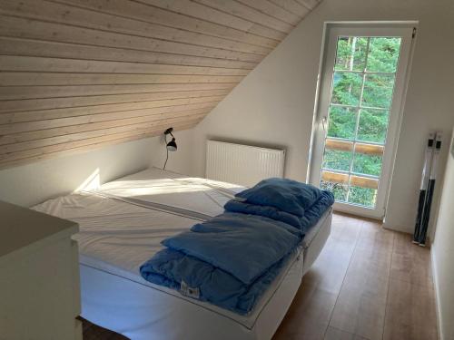 Bett in einem Zimmer mit Holzdecke in der Unterkunft Hegedal Apartment in Hobro