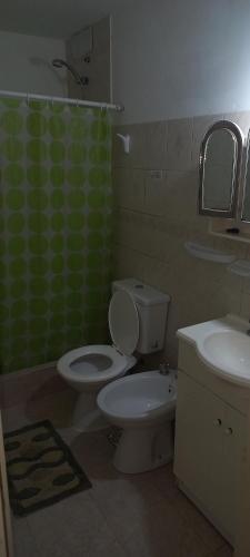 a bathroom with a white toilet and a sink at Duplex Cuty Nakey in Puerto Madryn